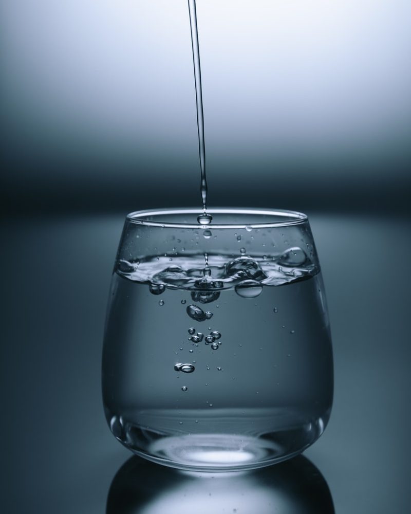 clear drinking glass on gray surface